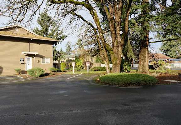 A building with a parking lot in front of it.