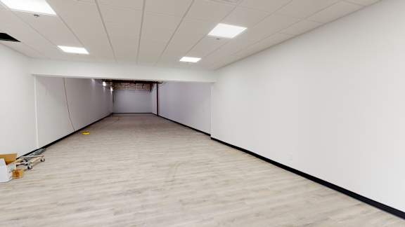 A room with a wooden floor and white walls.