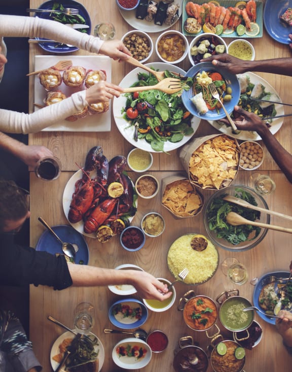 a group of people sitting around a table eating food