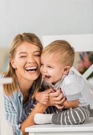 A woman and a child are sharing a joyful moment together.