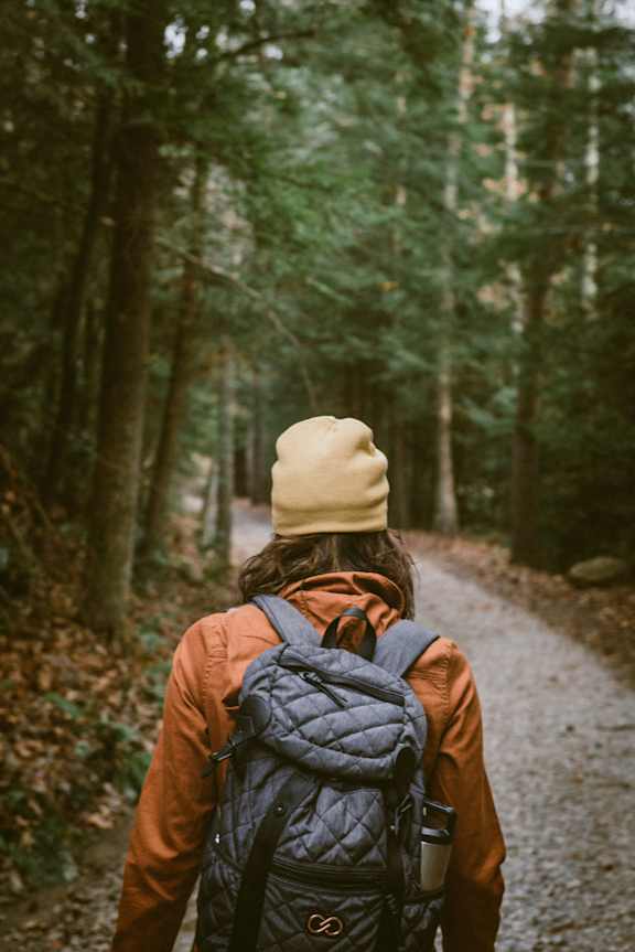 A person is walking in a forest at Red Rock Apartments, South Dakota
