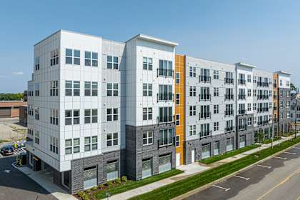an exterior view of an apartment building on a city street  at City View Apartments, Michigan