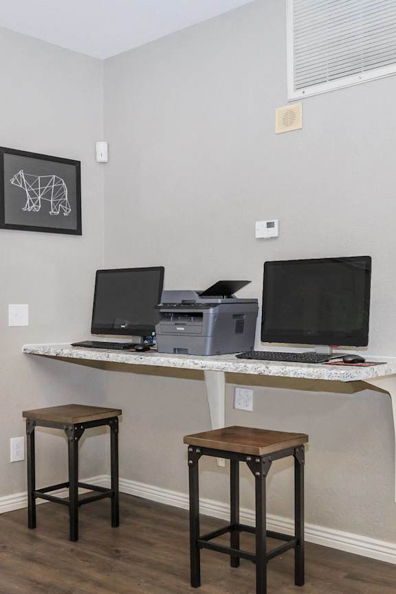 A room with a desk and two chairs.