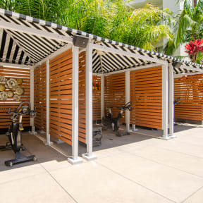 a gym with a variety of exercise equipment and a grill