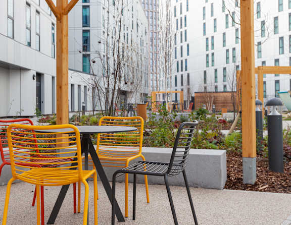A yellow chair sits next to a black chair.