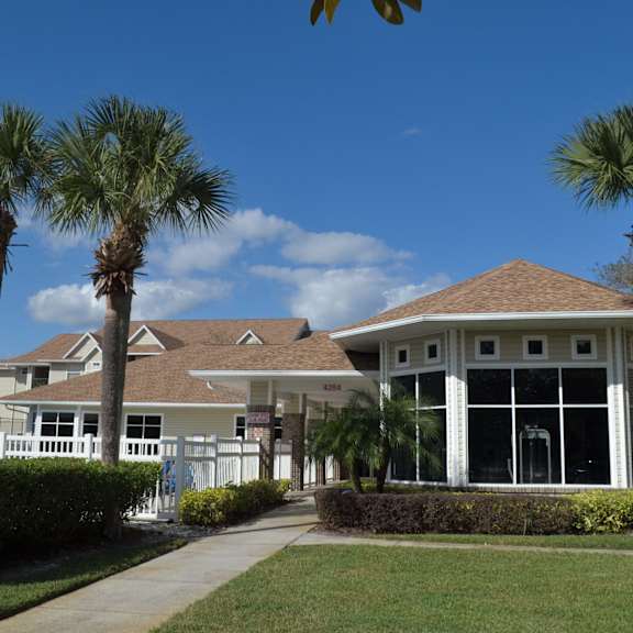 a house with palm trees in front of it