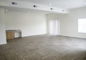 an empty room with a sink and a window