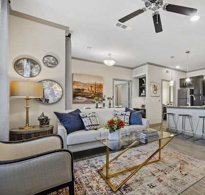a living room and kitchen with a couch and a table