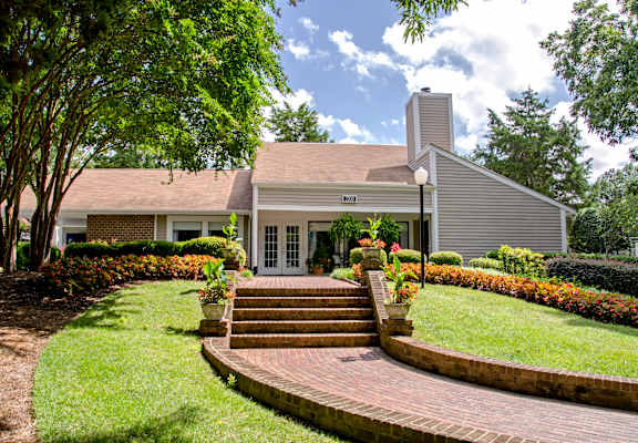 a house with a brick walkway leading up to the front door