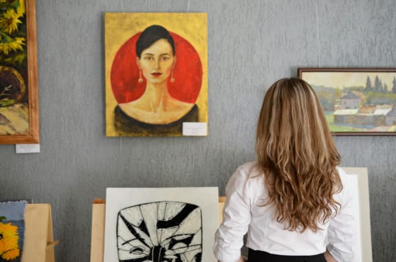 two young boys looking at paintings in an art gallery at The Box, Virginia