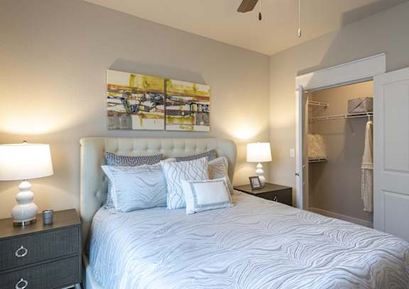 a bedroom with a bed and a ceiling fan