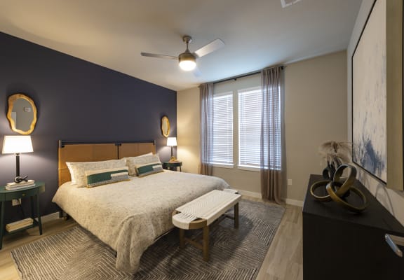 a bedroom with a bed and a ceiling fan