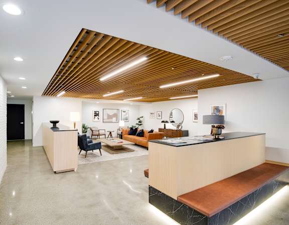 A reception area with a wooden ceiling and a white wall.