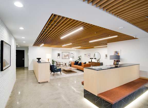 A reception area with a wooden ceiling and a white wall.
