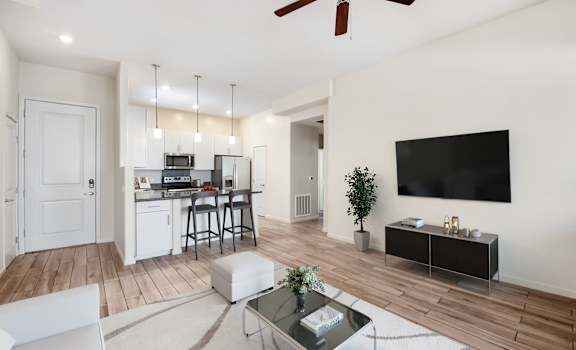 A modern living room with a bar area and a television.