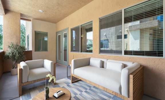 A living room with a sofa, armchair, and coffee table.