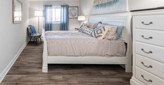 a bedroom with a white bed and white dressers at Fairbrook Park, Baltimore, 21244