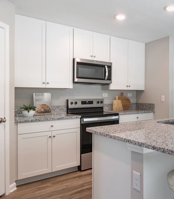 a bathroom with granite counter tops and a large mirror