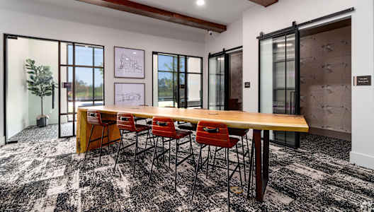 a conference room with a long wooden table and chairs