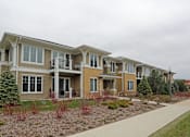 Thumbnail 5 of 31 - A row of houses with a sidewalk in front.
