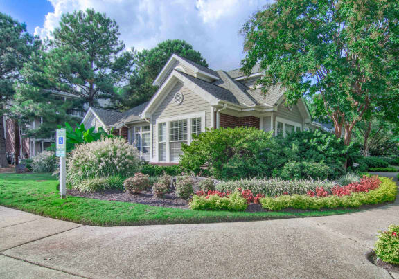 a house with a flower garden in front of it