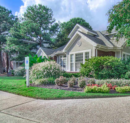 a house with a flower garden in front of it