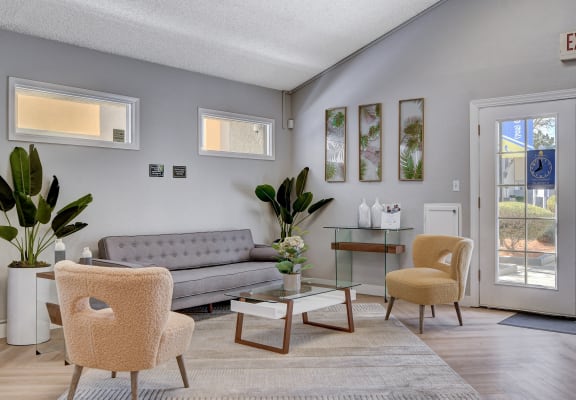 a living room with a gray couch and two yellow chairs at Summerlin Meadows, Las Vegas, NV