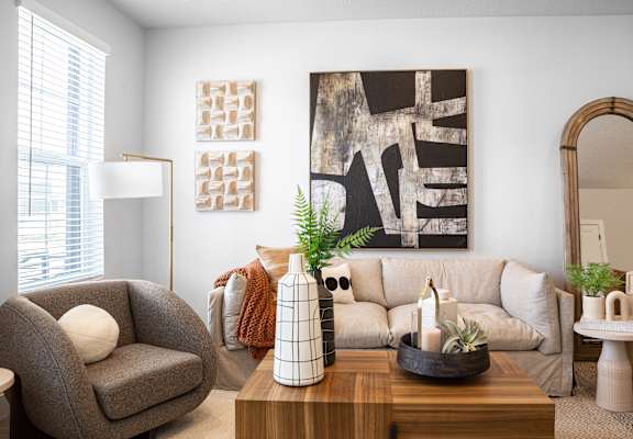a living room with a white couch and a wooden coffee table