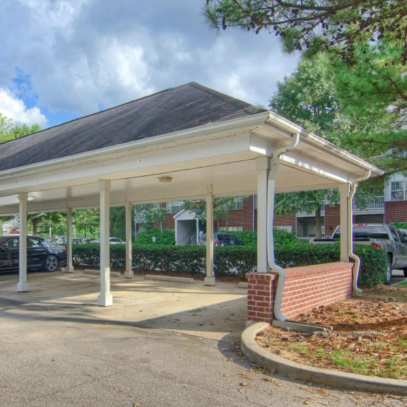 Enclave at Wolfchase Apartments in Cordova Tennessee photo of a covered parking lot with cars parked under it