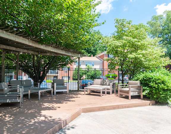 a patio with chairs and a pergola