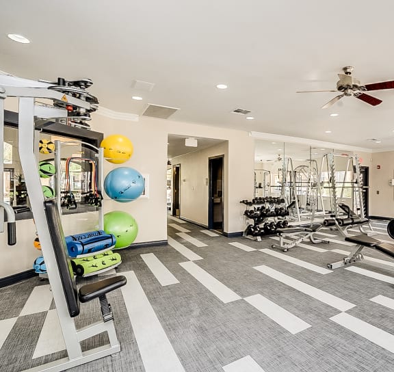 a spacious fitness center with weights machines and other exercise equipment
