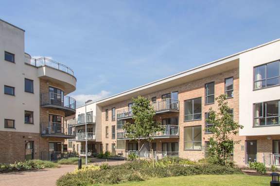 a group of apartments with balconies and a courtyard