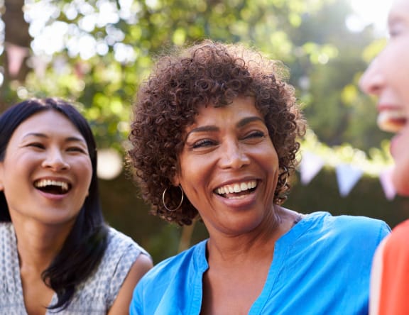 a group of women laughing and smiling together