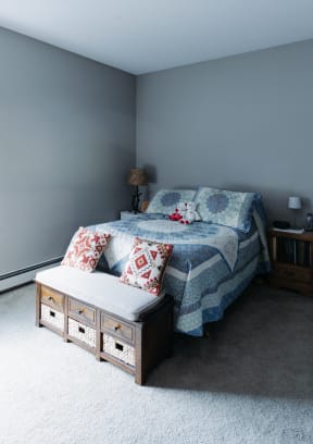 a bedroom with a bed and a chair and a window