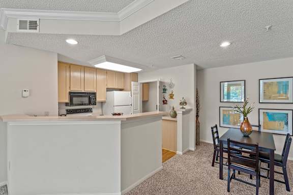A kitchen with a dining table and chairs.