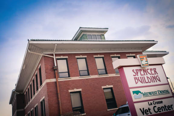 the front of a brick building with a sign in front of it