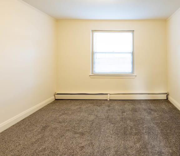 an empty room with carpet and a window at Loch Bend Apartments, Baltimore, Maryland, 21234