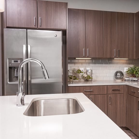 Kitchen with brown cabinets at The Kelley at Samuels Ave, Texas