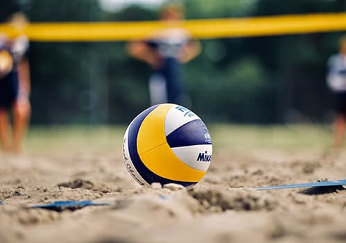 a volleyball sitting on top of a sandy beach