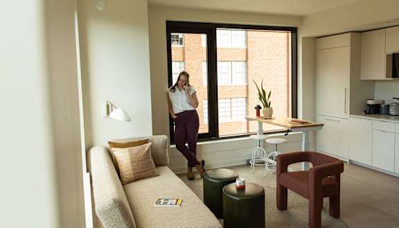 Woman standing in living room1 at Scout Living, powered by Placemakr, Atlanta, 30308