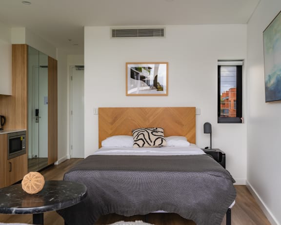 a bedroom with a bed and a round table