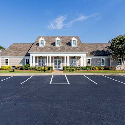 A large building with a parking lot in front of it.