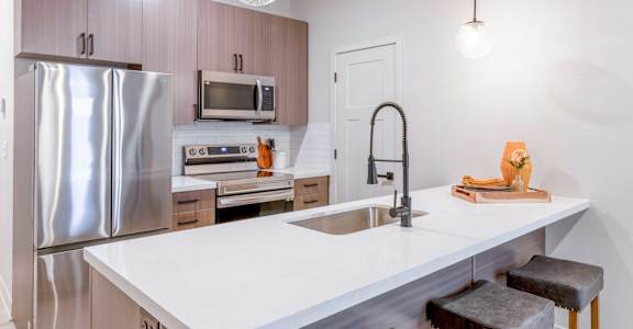 a kitchen with stainless steel appliances and a white counter top