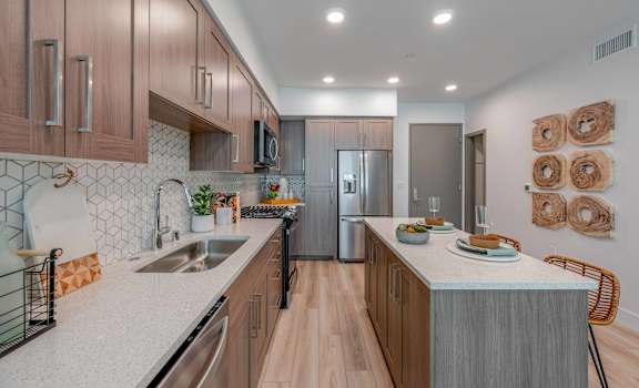 A kitchen with wooden cabinets and a white countertop.