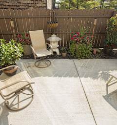 A patio with a chair and a table.