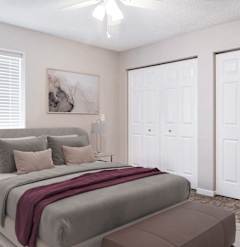A bedroom with a large bed and a painting on the wall.