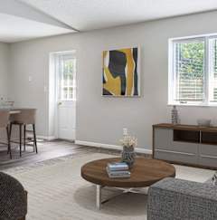 an empty kitchen with black appliances and white cabinets