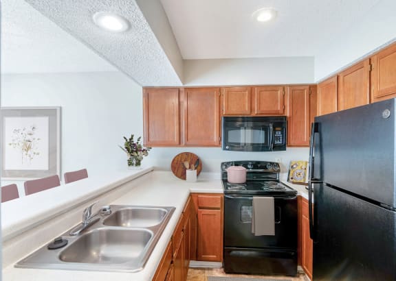 a kitchen with white cabinets and a black stove top oven