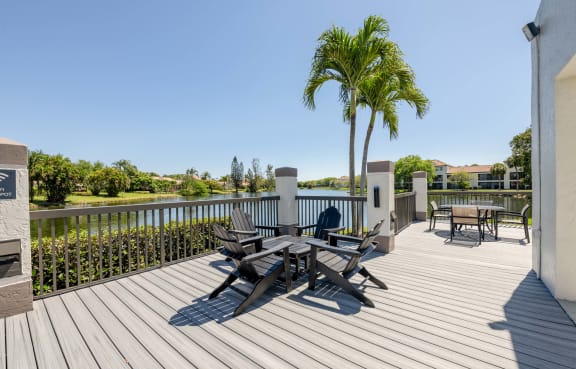 the deck has a palm tree and chairs on it