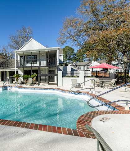 A swimming pool in front of a house.